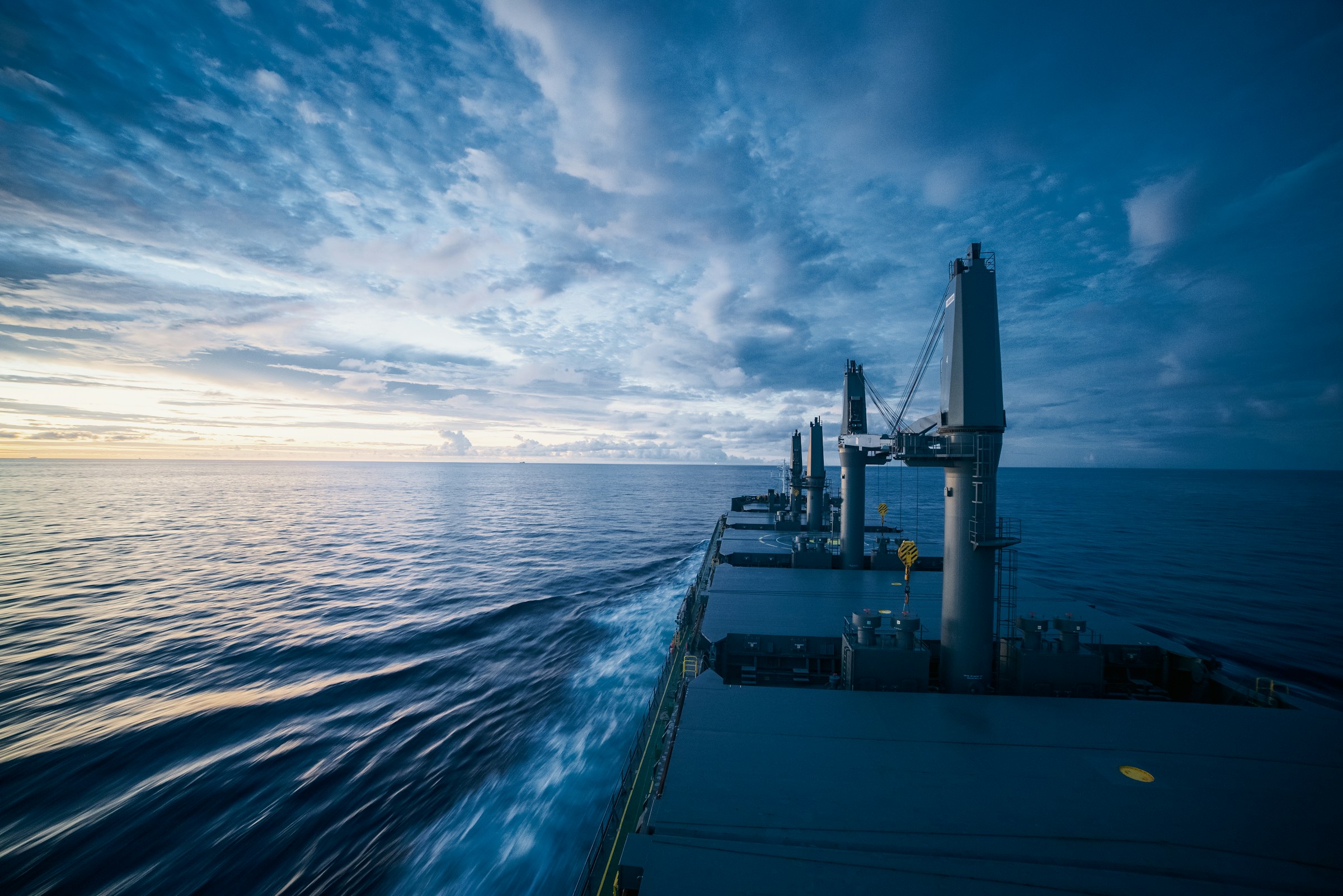 Deck of a vessel at sea, looking toward the horizon